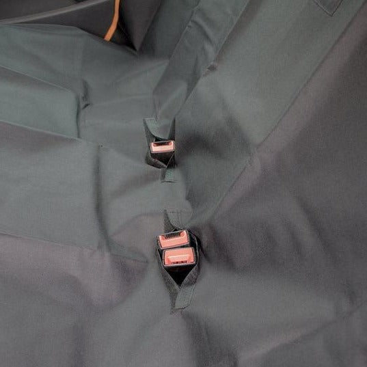 Close up of seatbelt openings on the RAC Rear Car Seat Cover For Dogs in use on the back seats of a car